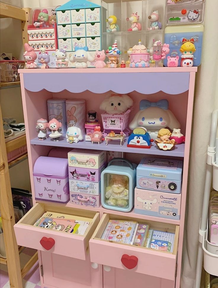 a pink shelf filled with lots of toys and other items on top of it's shelves