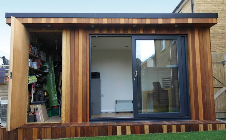 a small wooden building with sliding glass doors