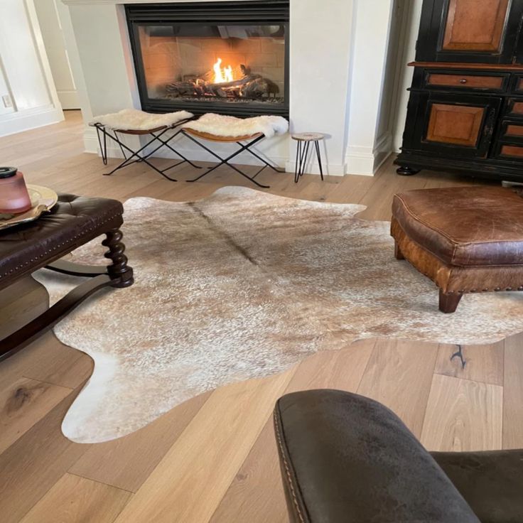 a living room filled with furniture and a fire place in the middle of the room