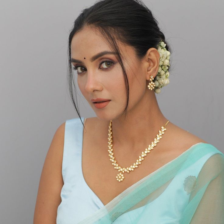 Description: Look classic with this simple and beautiful necklace from Tarinika. This Kundan necklace is a marvelous piece of beauty and will surely accentuate your look in a moment. Style it with any ethnic outfit of your choice and look your elegant best, effortlessly. Details & Specifications: Materials used: Brass Alloy with Matte Gold Platting Weight - Necklace 33 gm, Earrings 8 gm Length - Necklace 14 cm, Earrings 3 cm Make it custom Want to make it a custom Necklace? Sure! Reach out to us Elegant Kundan Jewelry Set For Navratri, Elegant Pearl Necklace With Tilla, Formal Kundan Necklace With Tilla, Kundan Jewelry Sets With Cutdana, Elegant Pearl Necklace For Festive Occasions, Elegant Pearl Necklace For Festive Celebrations, Diwali Temple Jewelry Style Kundan Necklace, Elegant Temple Jewelry Kundan Necklace, Elegant Chandbali Kundan Necklace With Cutdana