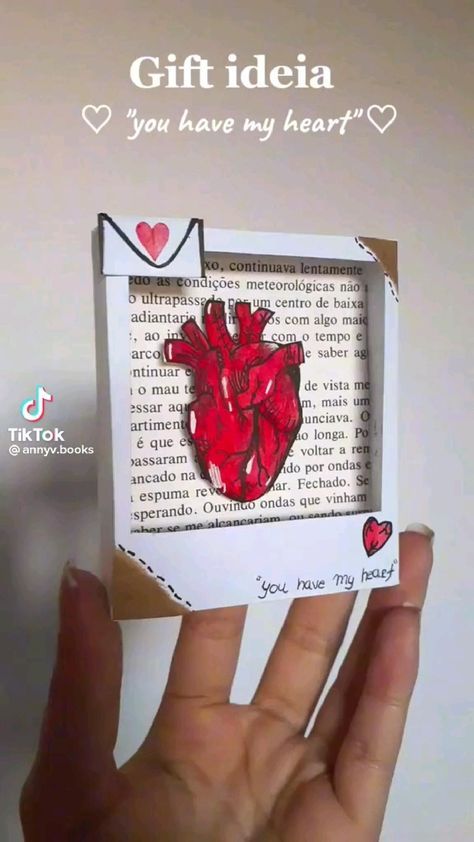 someone is holding up a small card with a heart in the middle and words on it