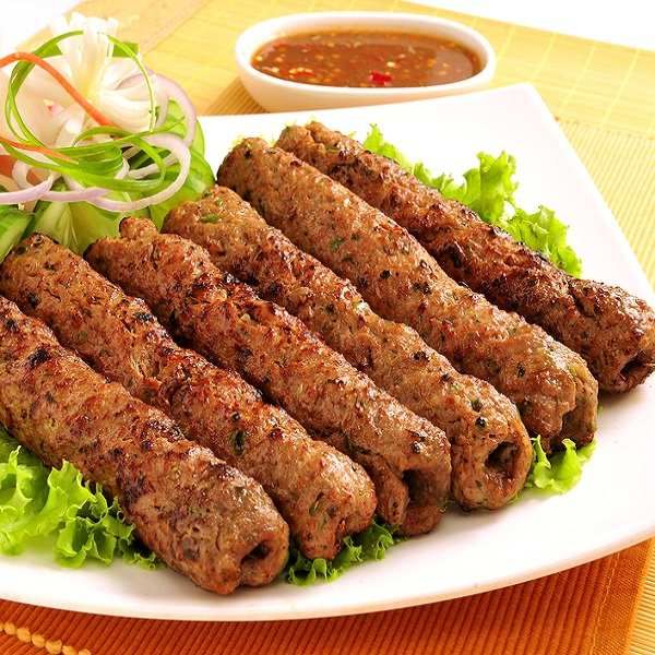 several skewers of meat on a plate with lettuce