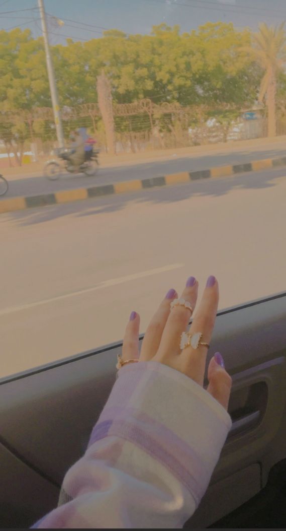 a woman's hand on the dashboard of a car