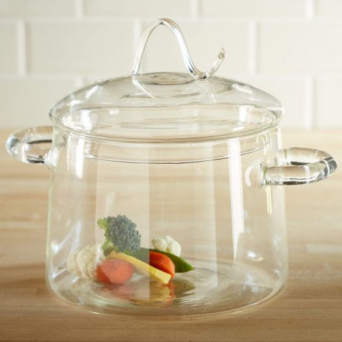 a glass pot with some vegetables in it