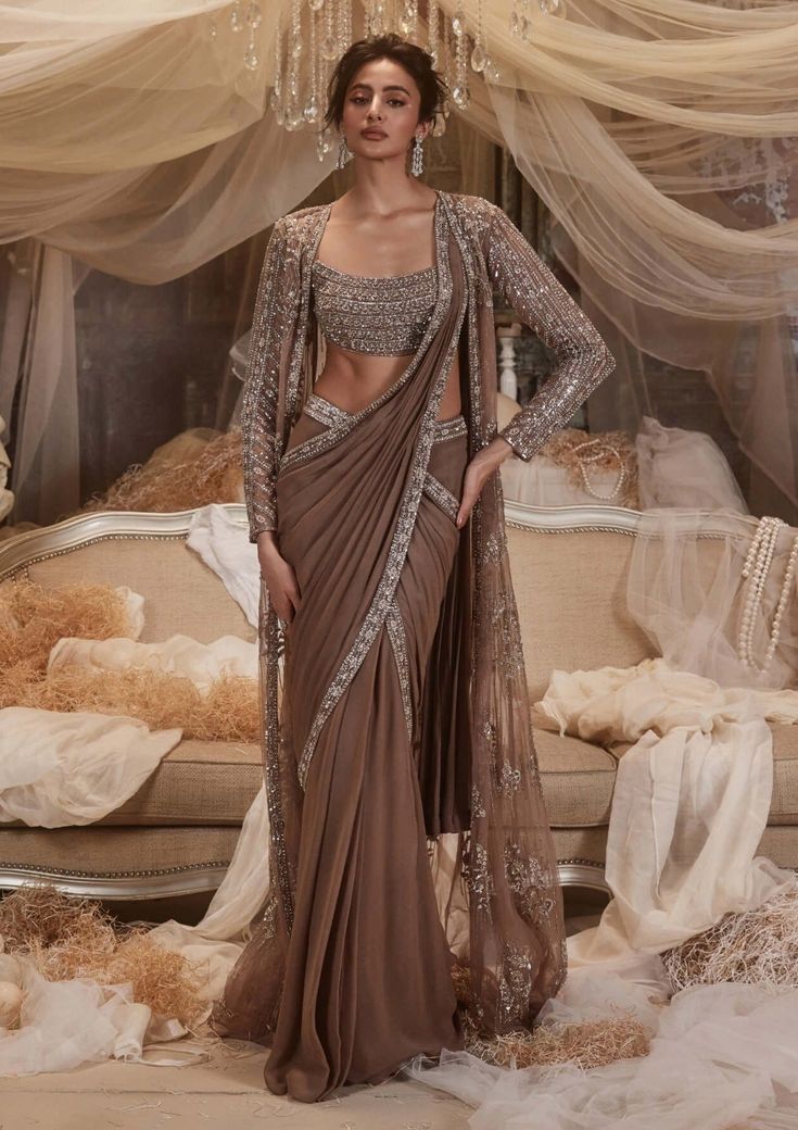 Antares Ash Brown Drape Sari And Jacket Set by Roqa, available on Indiaspopup.com Drape Saree With Cape, Modern Sari Designs, Lengha Saree Draping, India Wedding Outfits, Drape Saree With Jacket, Dupatta Drapes For Lehenga, Pre Draped Saree Gown, Indian Sari Dress Traditional, Western Sarees Fashion