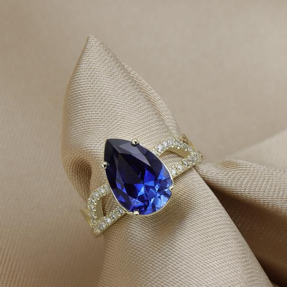 A Sapphire ring ring rich with presence and diamonds.Flaunting a beautiful pear cut Sapphire corundum prong set in your choice of solid gold.Handmade by an inspired jewelry artist team with decades of experience in the craft of jewelry making.Each gemstone, each diamond is carefully picked.Using only the finest raw materials and the highest industry standard in manufacturing, design and finish.A beautiful vintage inspired piece handmade just for you.Set with a 12x8 pear cut blue sapphire corundu Fine Jewelry Pear-shaped Sapphire Ring, Luxury Pear-shaped Sapphire Ring With Prong Setting, Pear-shaped Yellow Gold Sapphire Ring, Fine Jewelry Yellow Gold Sapphire Ring Pear-shaped, Fine Jewelry Yellow Gold Pear-shaped Sapphire Ring, Yellow Gold Pear-shaped Sapphire Ring, Elegant Pear-shaped Sapphire Ring For Formal Occasions, Teardrop Gemstone Ring For Formal Occasions, Elegant Formal Pear-shaped Sapphire Ring