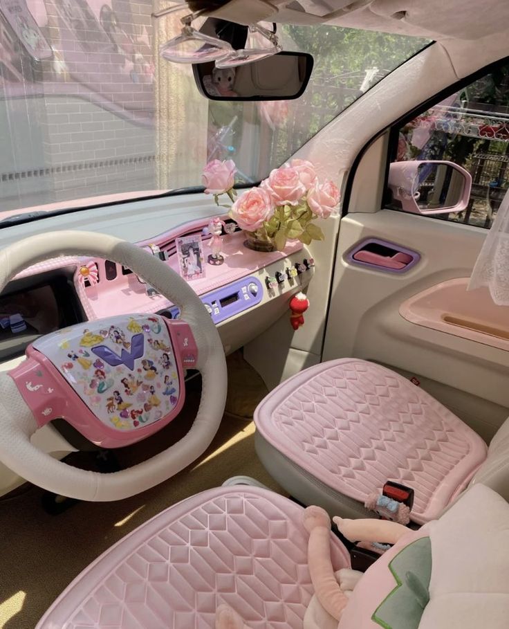 the interior of a car with pink and white accessories