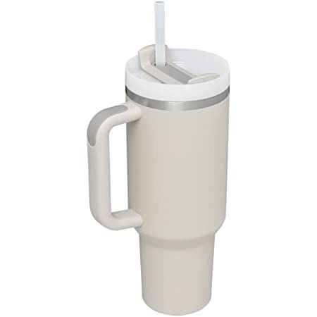 a white coffee cup with a straw sticking out of it's lid and handle