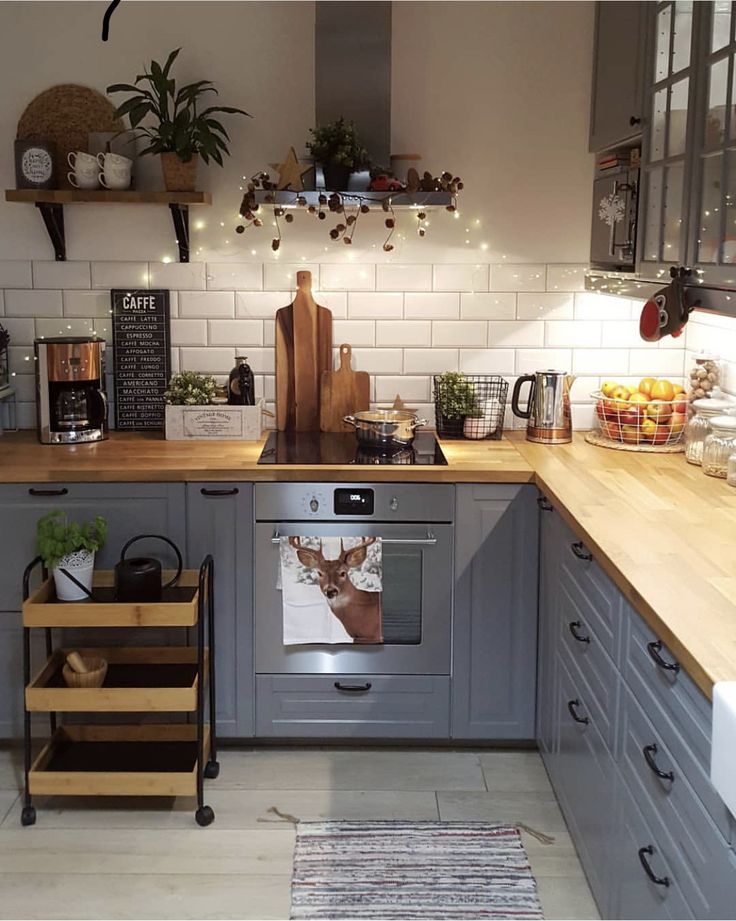 the instagram app is showing an image of a kitchen with grey cabinets and wooden counter tops