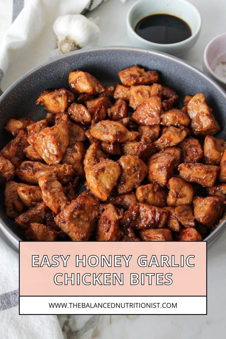 honey garlic chicken bites in a bowl on a table next to some dipping sauces