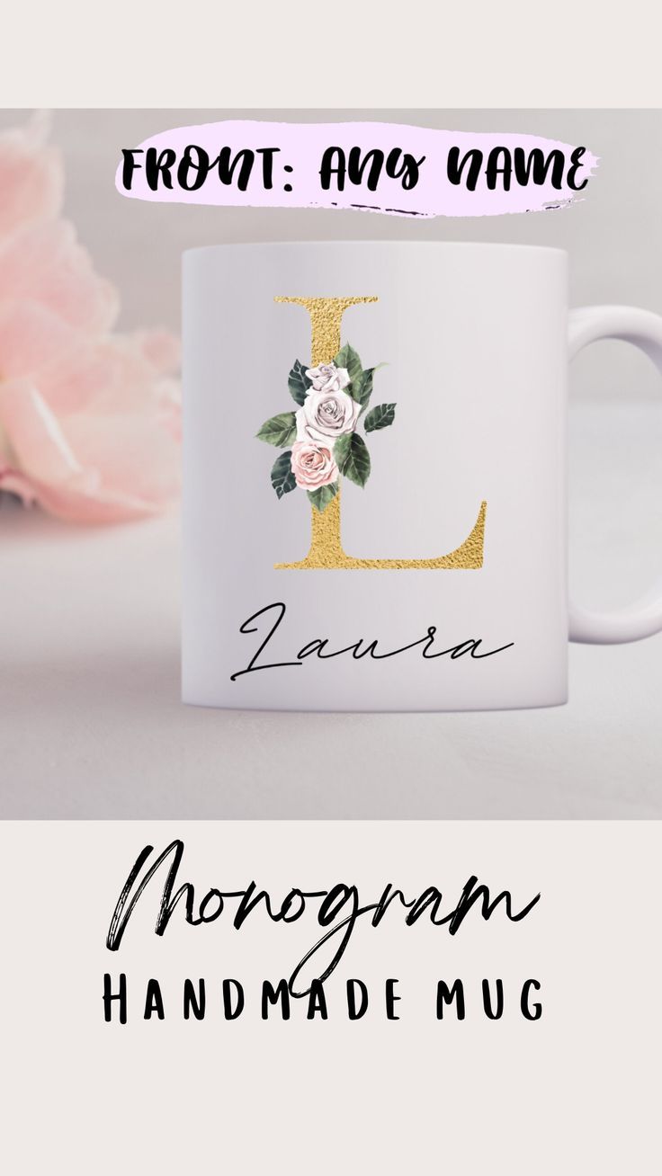 a coffee mug with the letter l on it and some flowers in front of it