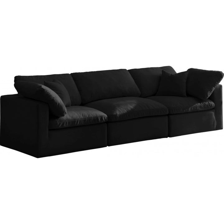 a black couch with four pillows on it's back and the seat folded down