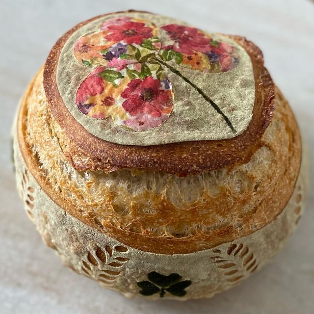 a close up of a round cake with flowers on it