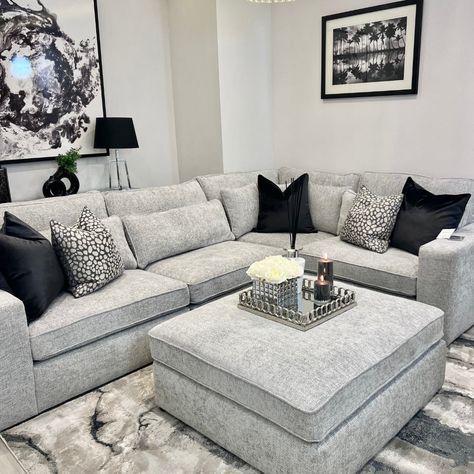 a living room filled with lots of furniture and pillows on top of a carpeted floor