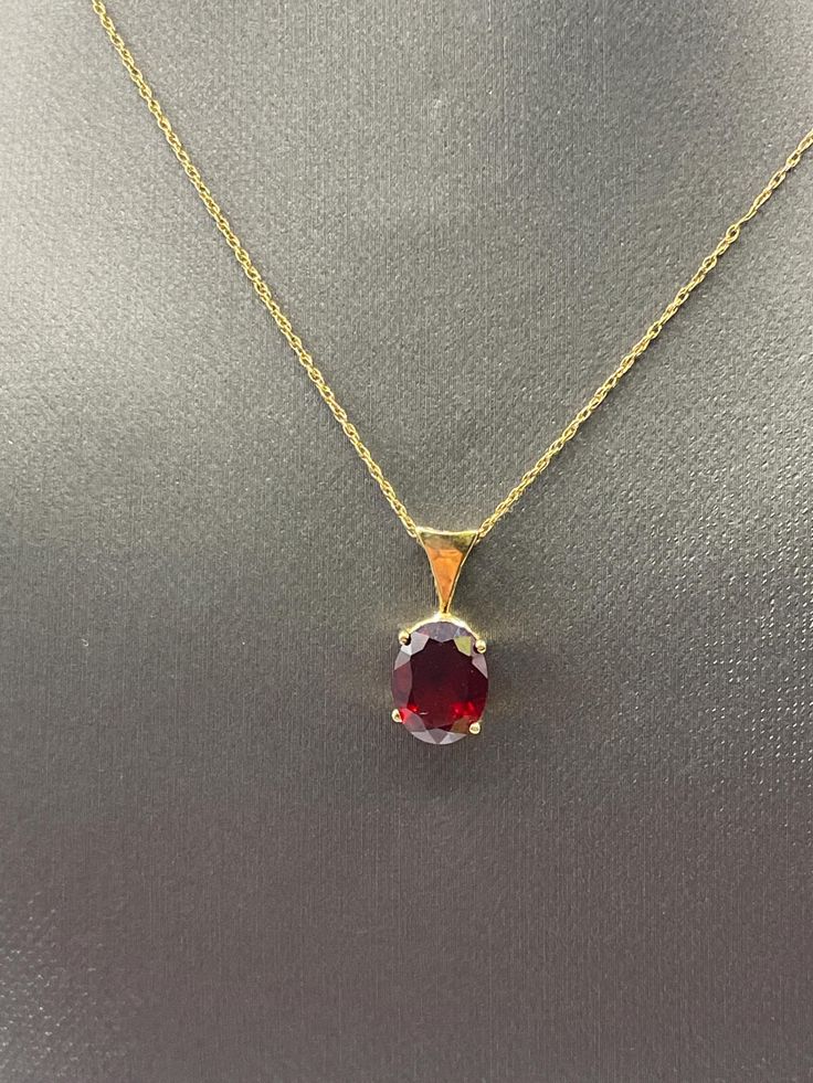 An elegant ladies oval shaped Garnet pendant hangs on a 14 karat solid yellow gold open link sparkle chain. Weight:  1.9 grams Length:  21 ½ " long Our Price $225.00 Regularly Priced At $450.00 Please See Our Video Remember - If you're purchasing for yourself or a gift for a loved one, buy with confidence.  We Guarantee Everything We Sell!  SKU # N741 Formal Oval Diamond Cut Necklaces, Formal Oval Diamond Cut Necklace, Classic Yellow Gold Oval Pendant Necklace, Classic Oval Diamond Cut Necklace, Classic Oval Necklace For Formal Occasions, Classic Oval Necklace For Formal Events, Classic Oval Necklaces For Formal Occasions, Formal Jewelry With Oval Pendant And Cable Chain, Yellow Gold Formal Necklace With Oval Pendant