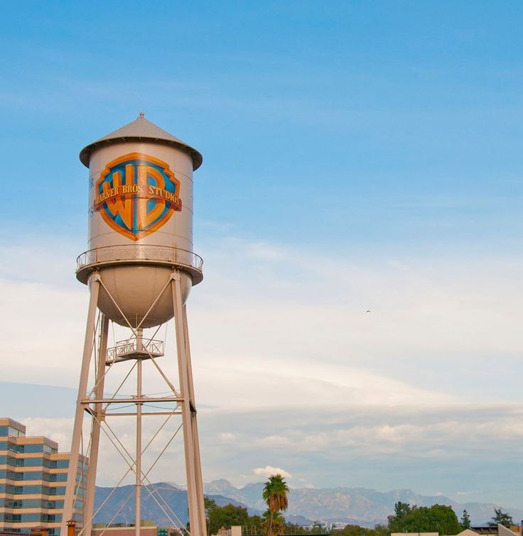 a tall water tower with a logo on it