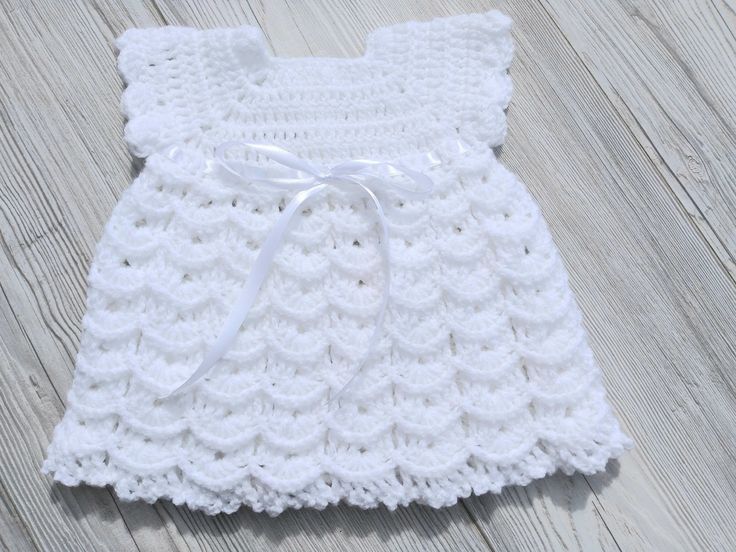 This crochet dress is perfect for any girl. It would make a wonderful baptism, christening or baby shower gift. This dress is a great gift for any new born, baby or toddler. The added detail of a ribbon makes it even more special. This crochet dress has short sleeves and can be made in different colours. A matching cardigan is available in EbonyStitch.  This dress is made to order and can be made to your desired length. Please contact me to discuss colour and size. I always look forward to your New Born Baby, Christening Dress, Crochet Baby Dress, How To Make Ribbon, Gender Neutral Baby Clothes, Gift For Girls, Dress Gift, Toddler Dress, Gender Neutral Baby