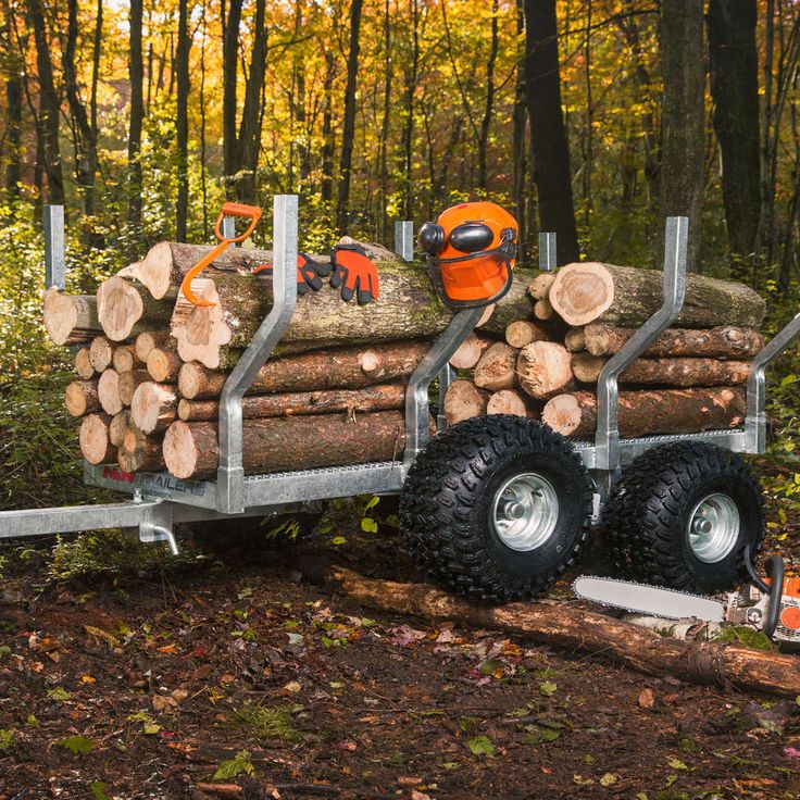 a trailer loaded with logs in the woods