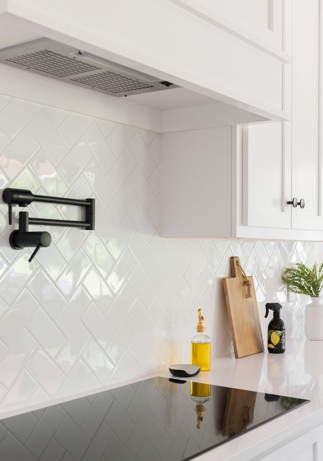 a kitchen with white cupboards and black counter tops is seen in this image from the front view