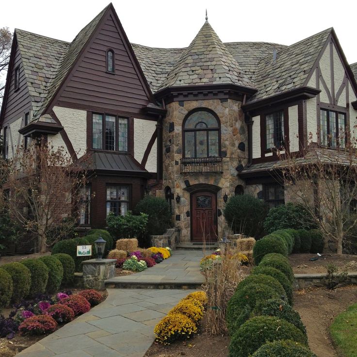 a large house with lots of flowers in front of it