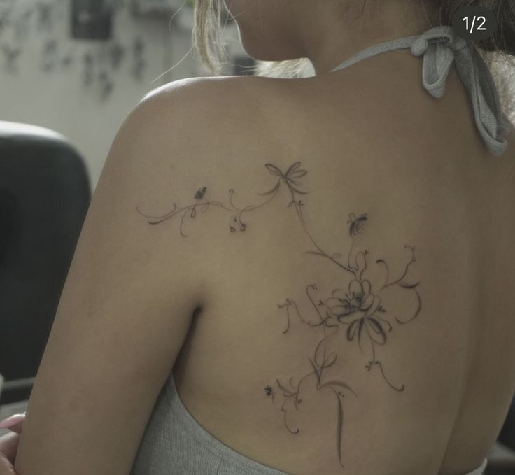 a woman with a tattoo on her back