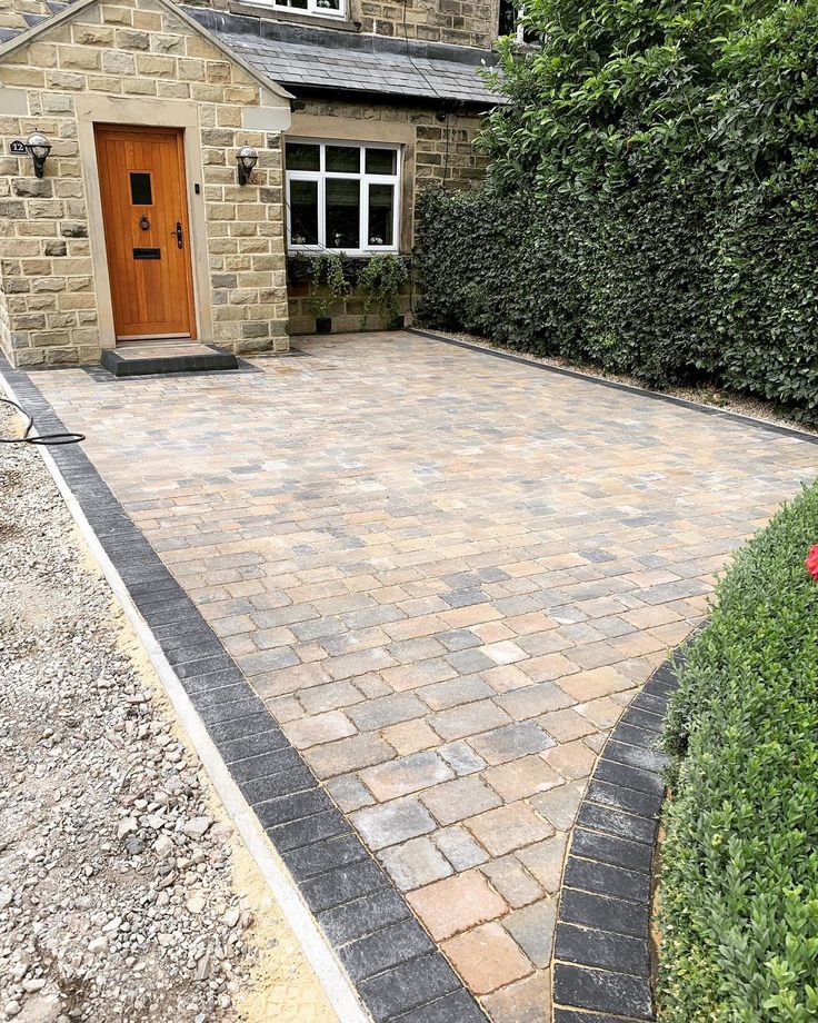 a brick driveway in front of a house