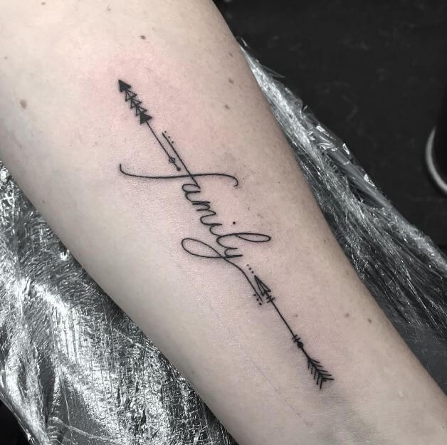 a tattoo on the arm that says faith with arrows and an arrow in script above it