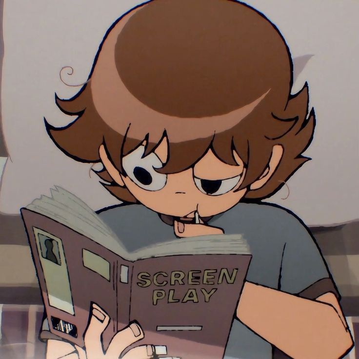 a young boy reading a book while wearing glasses