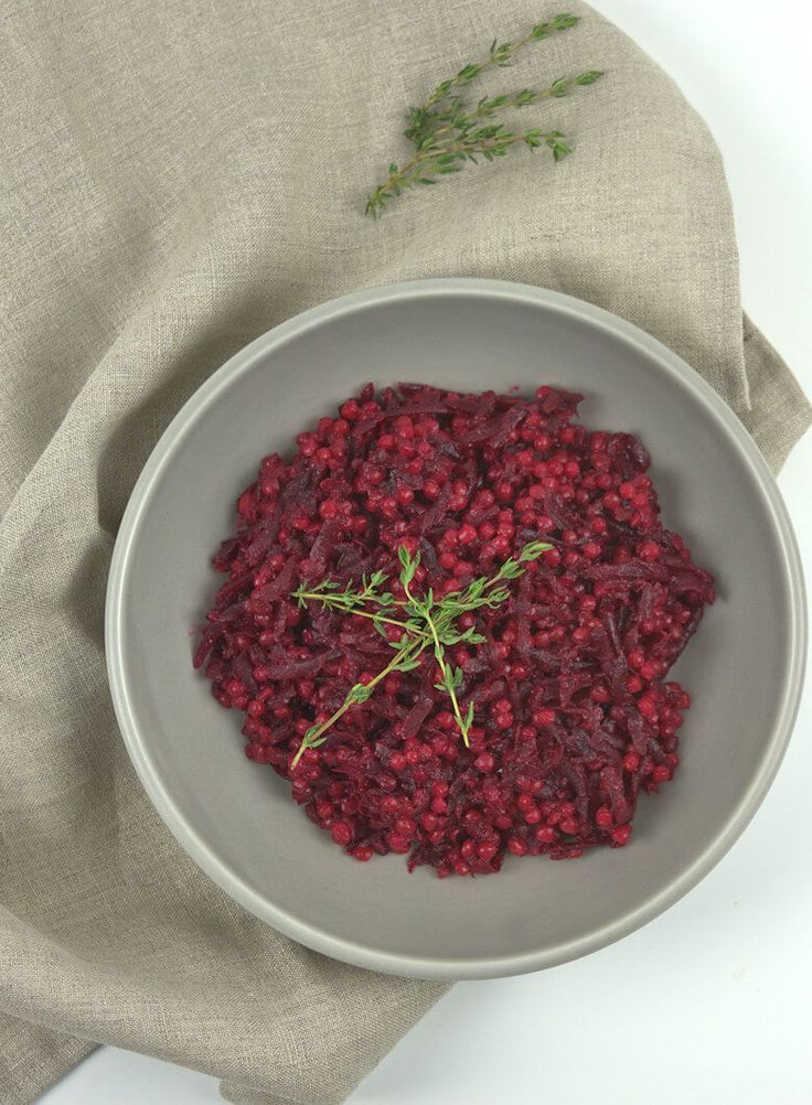 a bowl filled with red food on top of a table