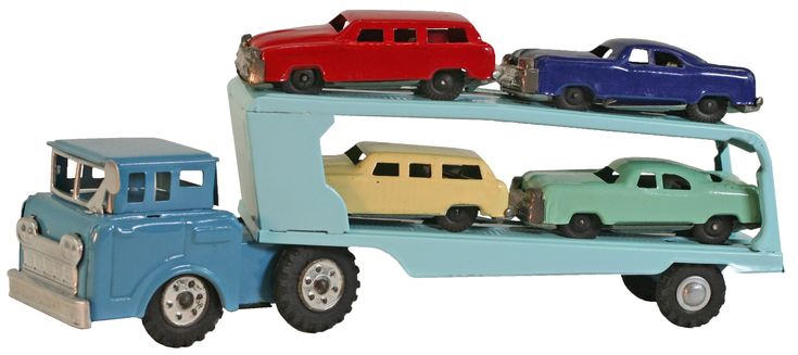 three toy cars are on top of a truck