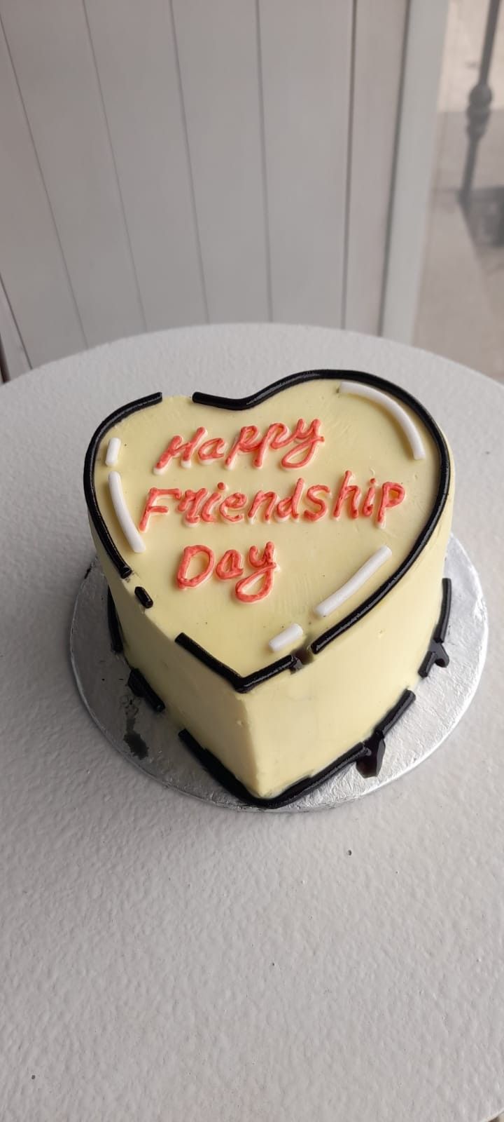 a heart shaped cake with the words happy friendship day written on it