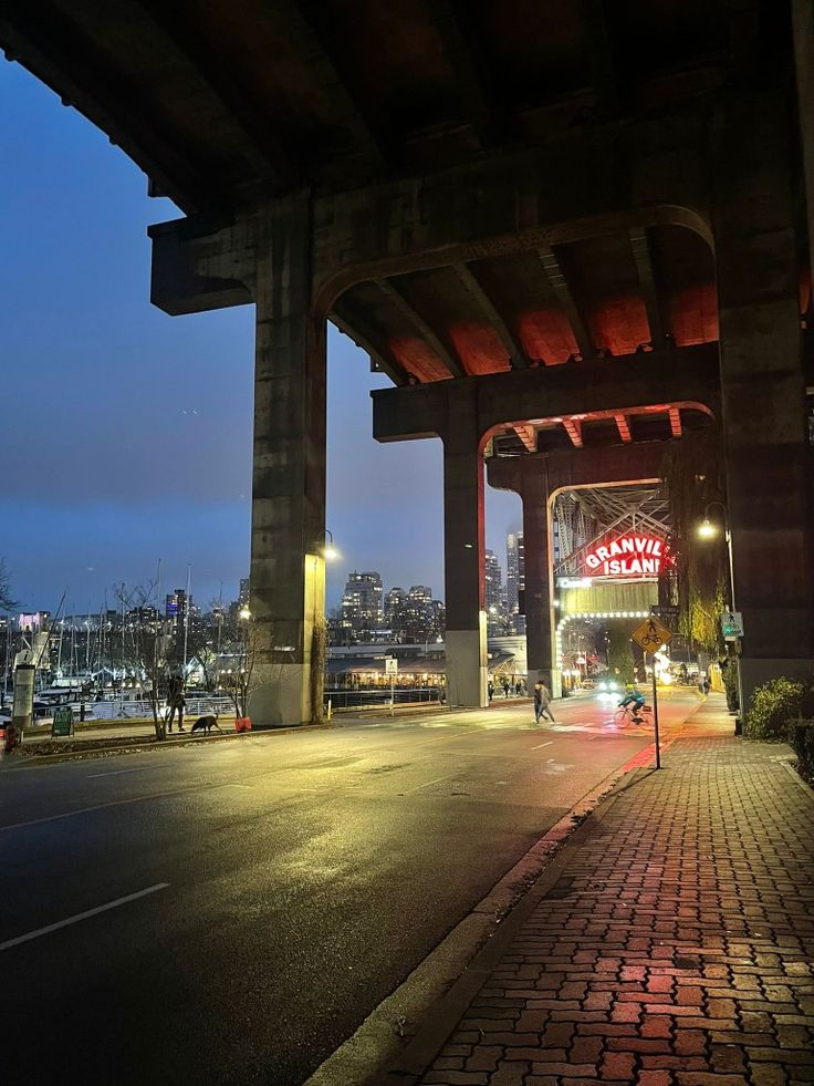 an overpass with cars driving under it at night