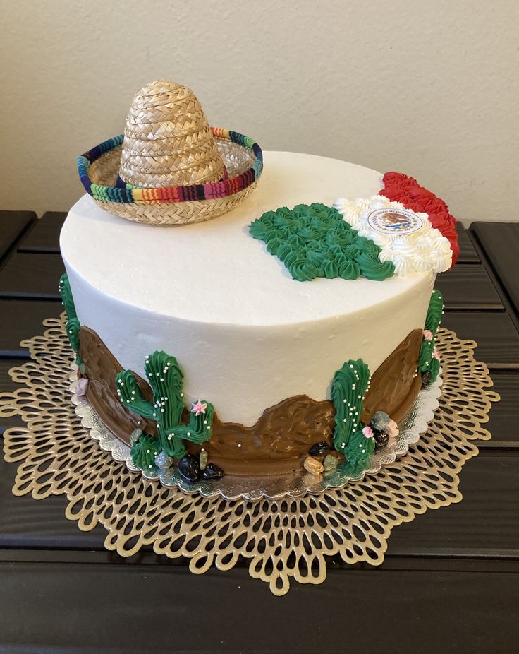 a white cake decorated with mexican themed decorations