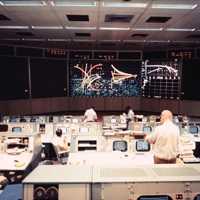 the control room is full of people working on their computers