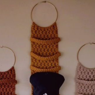 three crocheted items hanging on the wall