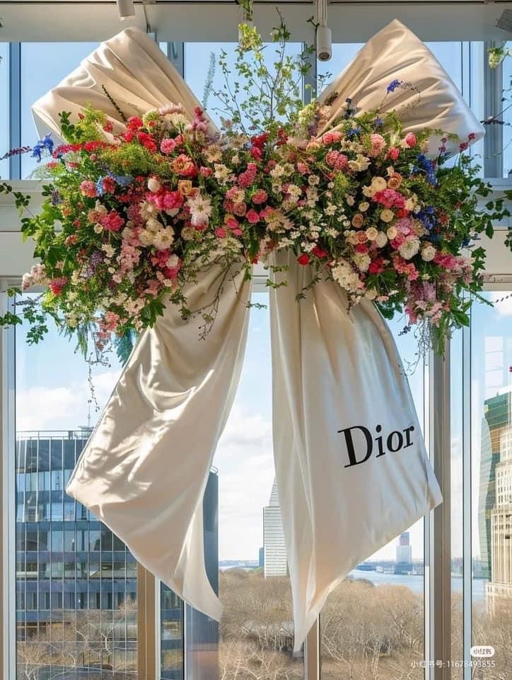 a floral display hanging from the side of a window