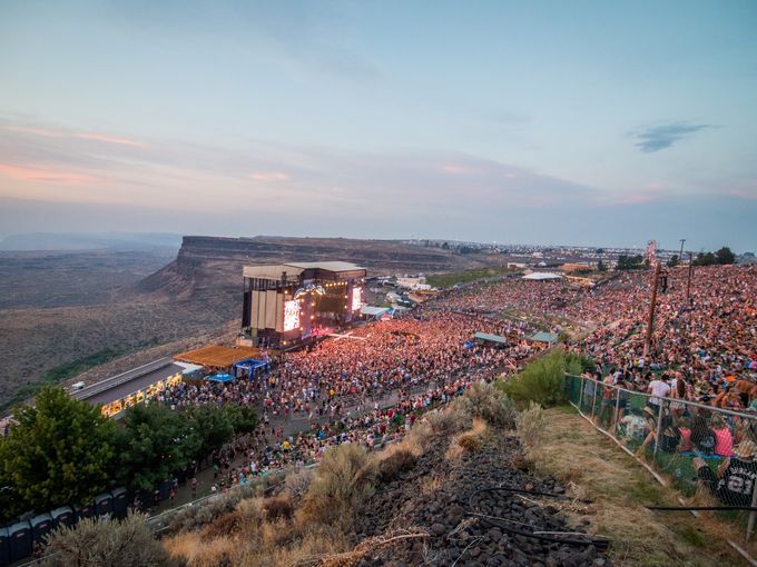 an aerial view of a concert in the mountains