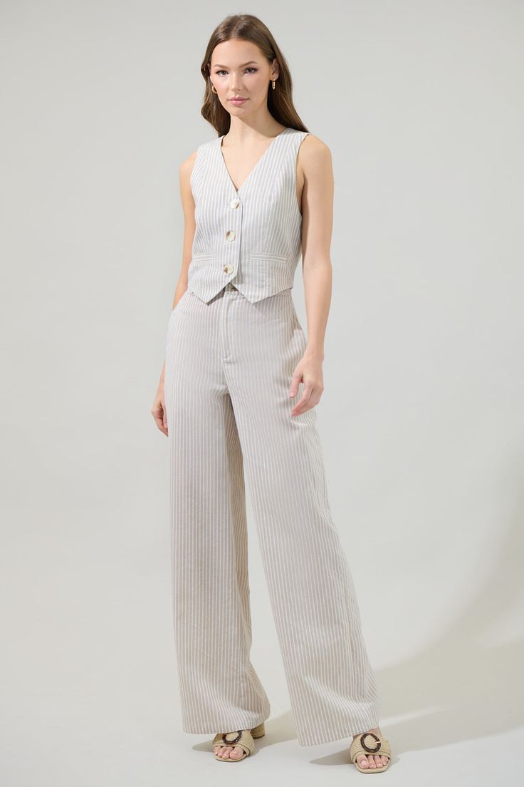 From the office to the after-work drink, the Sandy Striped Chelsea Button Up Vest is the elevated look you need to beat the midweek blues! Features a sleeveless, tailored fit with princess seams and a button up in the front. Adjust the waist by tightening or loosening the tie along the back panel. Wear it alone or add on the matching pants for a set.- Waistcoat- Adjustable- Stripe- Cropped- Color: Blue StripeSize + Fit - Model is 5'8" and wearing size XS- Measurements taken from size S - Chest: After Work Drinks, Cropped Jumpsuit, Graphic Apparel, Princess Seams, Matching Pants, Princess Seam, Navy And Green, Wide Leg Trousers, Tee Shop