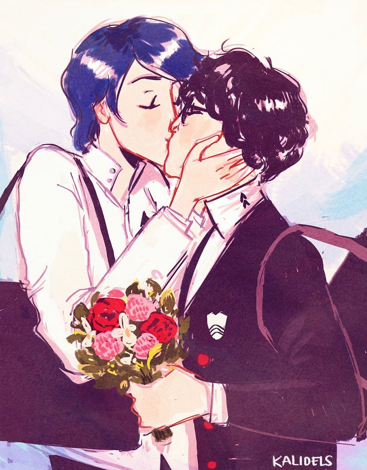 two people kissing each other while holding flowers