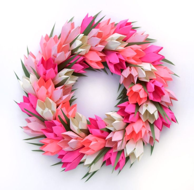 a wreath made out of pink and white paper