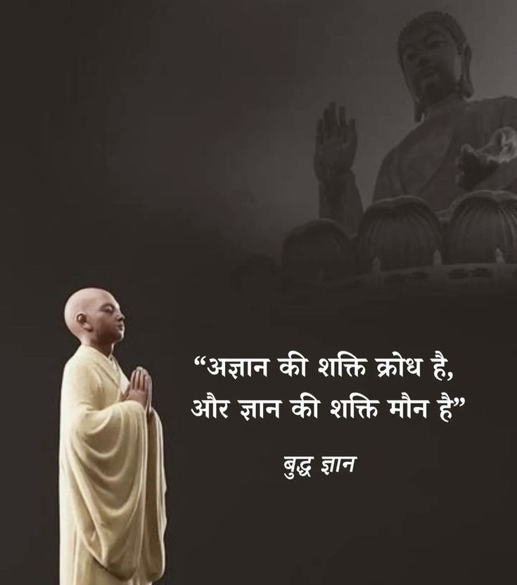 a man standing in front of a buddha statue with his hands clasped to his chest