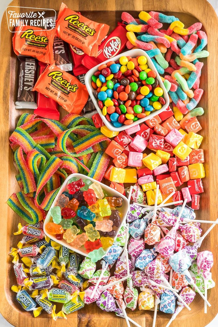 a wooden tray filled with candy and candies