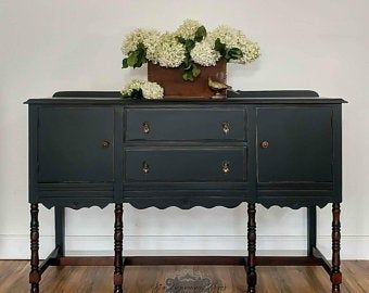 a black dresser with flowers on top of it