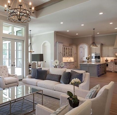 a living room filled with furniture and a chandelier