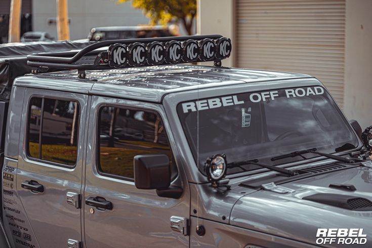 the jeep is parked on the side of the road with its roof rack mounted to it