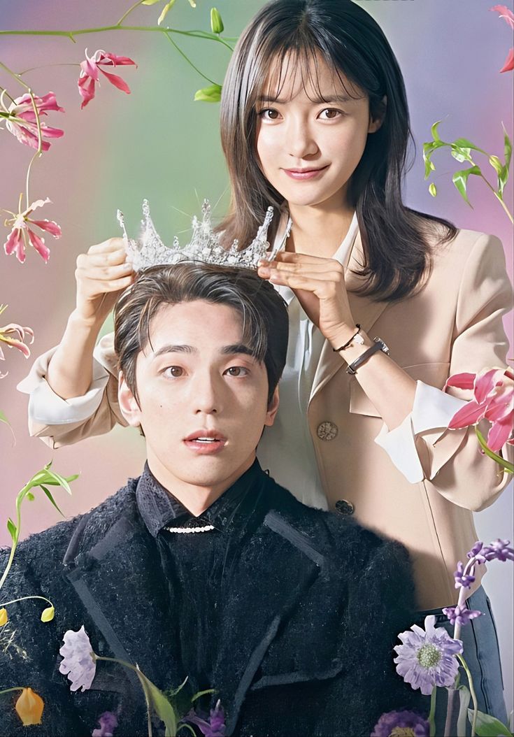 a man standing next to a woman with a crown on her head in front of flowers