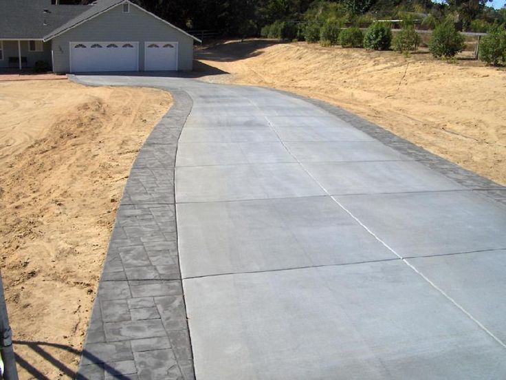 an empty driveway in front of a house