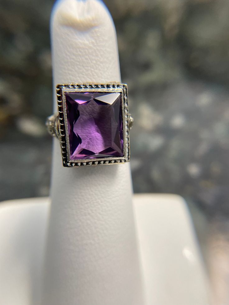 Art Deco Filigree work ring in 14K White Hold. This holds a beautifully cut Anethyst almost rectangular shaped stone. This is a finger size 4 1/2. This could be sized up 2 sizes. It's in immaculate condition.  Circa 1925 Weight 4.26 grams Stone approximately 5.00 carats. Formal Purple Amethyst Ring With Rectangular Shape, Formal Rectangular Amethyst Ring, Formal Rectangular Purple Amethyst Ring, Classic Amethyst Ring With Rectangular Stone For Formal Occasions, Elegant Rectangular Amethyst Ring For Formal Occasions, Classic Purple Rectangular Rings, Classic Rectangular Amethyst Ring, Hallmarked Emerald Cut Amethyst Rings, Emerald Cut Hallmarked Amethyst Ring