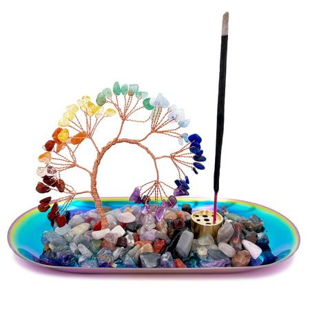 a glass plate with rocks and a tree on it that has a pencil in it