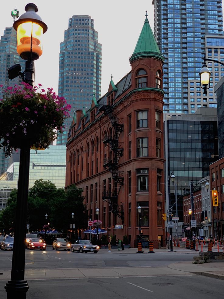 a city street with tall buildings in the background